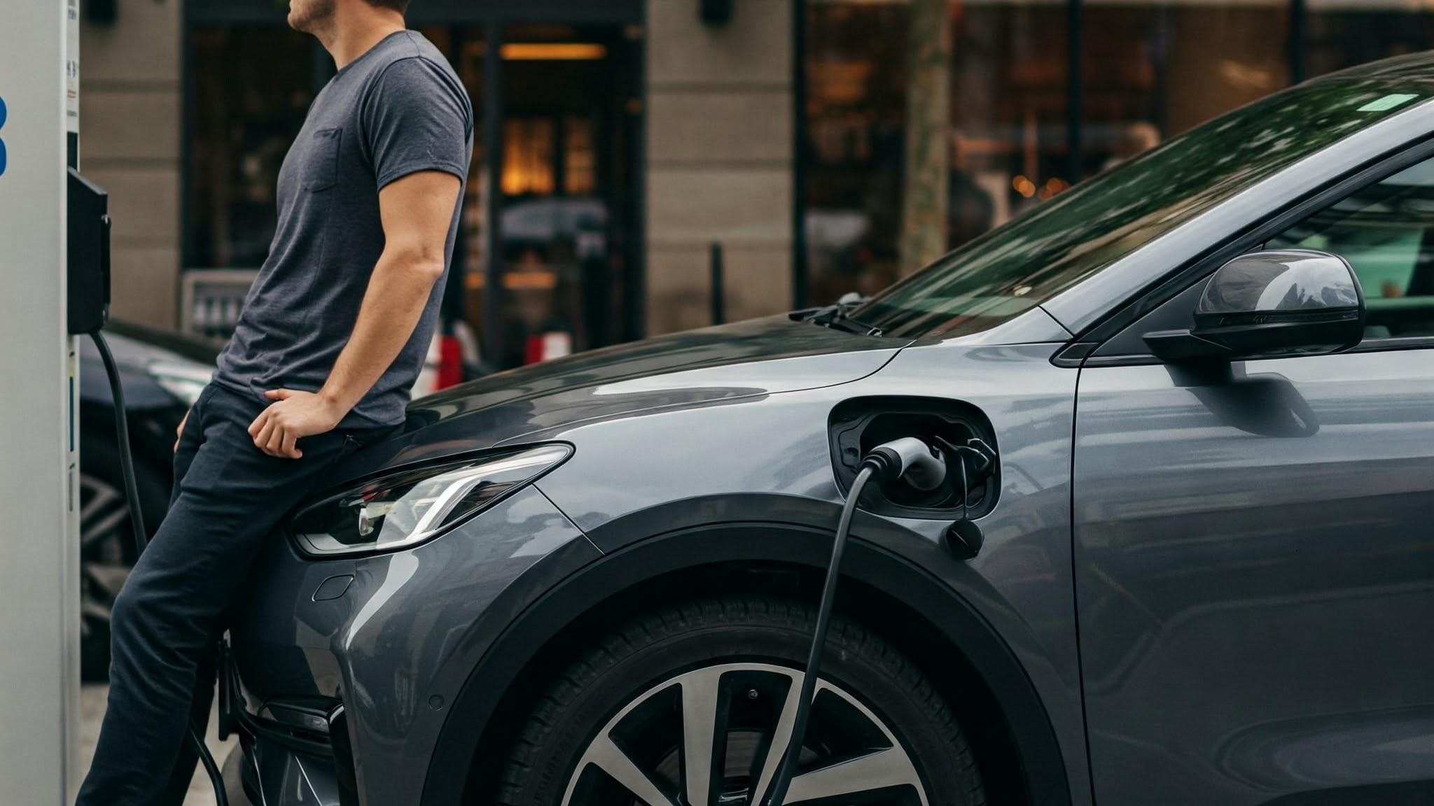 Parking lot of electric cars with charging stations.